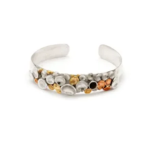 Pebbles on a beach cuff with stone